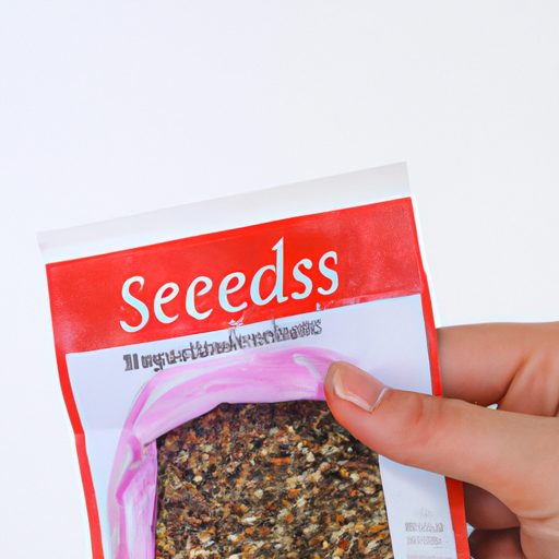 a hand holding a packet of organic seeds 512x512 75248958