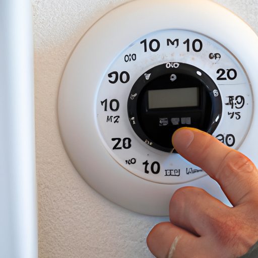 a person adjusting a thermostat dial pho 512x512 64150311